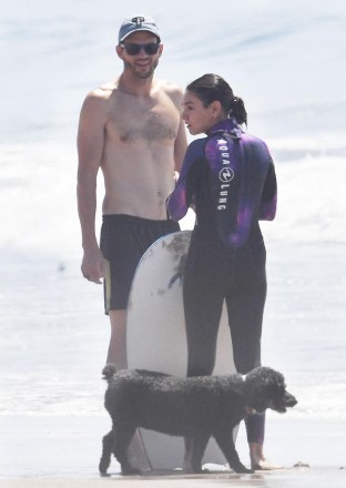 EXCLUSIVE: Ashton Kutcher and Mila Kunis spend Labor Day weekend at the beach to cool off after Sunday's sweltering Santa Barbara heatwave. Ashton used a surfboard and body board to catch the waves while Mila did a bit of boogie boarding and body surfing Mila used a wetsuit while catching the waves Ashton recently revealed that he suffered from vasculitis a few years ago and said he had struggled to recover but is fine now He recently revealed a significant weight loss as well September 04, 2022 Pictured: Ashton and Mila go surfing . Photo Credit: Garrett Press/MEGA TheMegaAgency.com +1 888 505 6342 (Mega Agency TagID: MEGA892118_047.jpg) [Photo via Mega Agency]